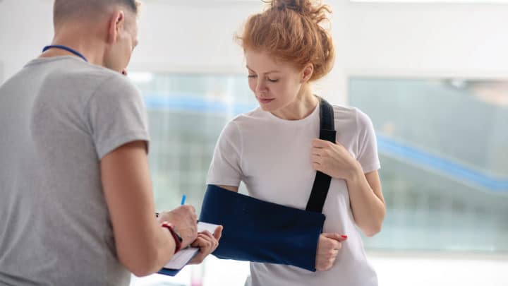 a woman who has an injury to her arm visits a medical provider